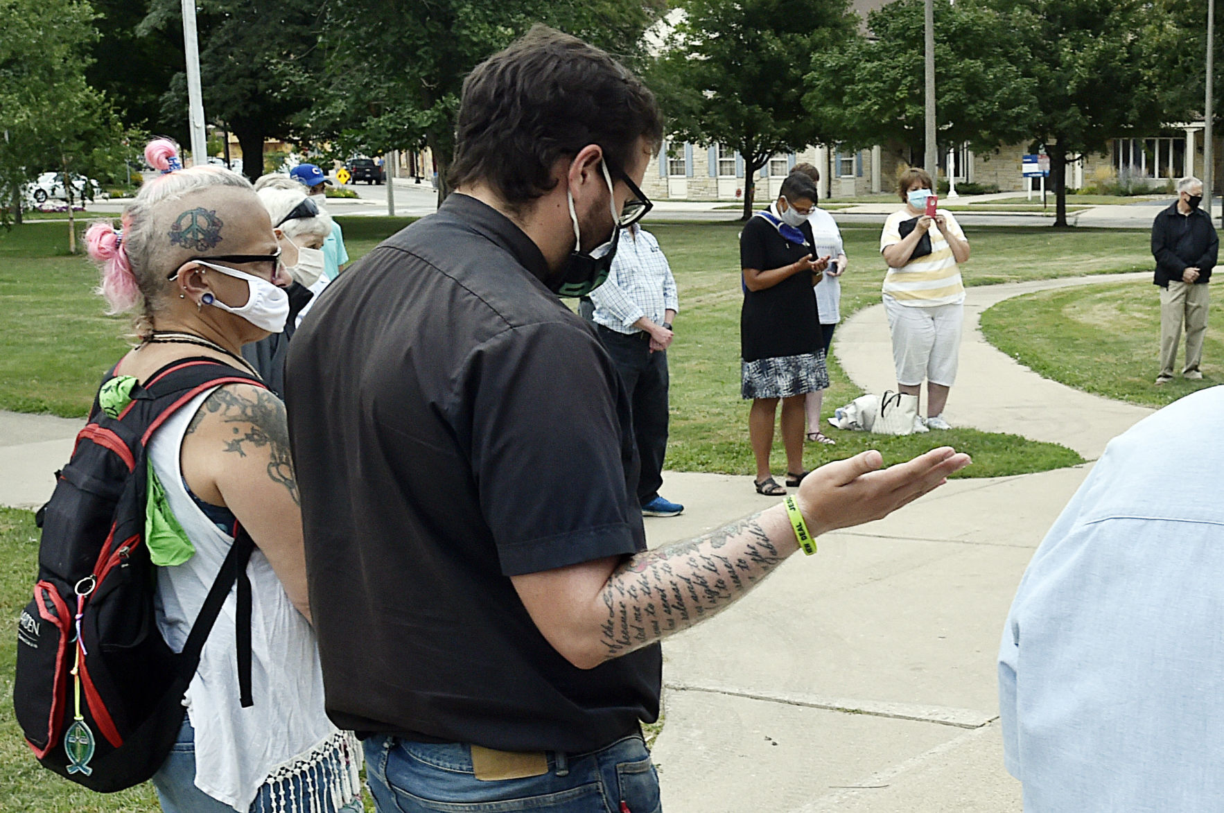 A man and woman hold hands in prayer